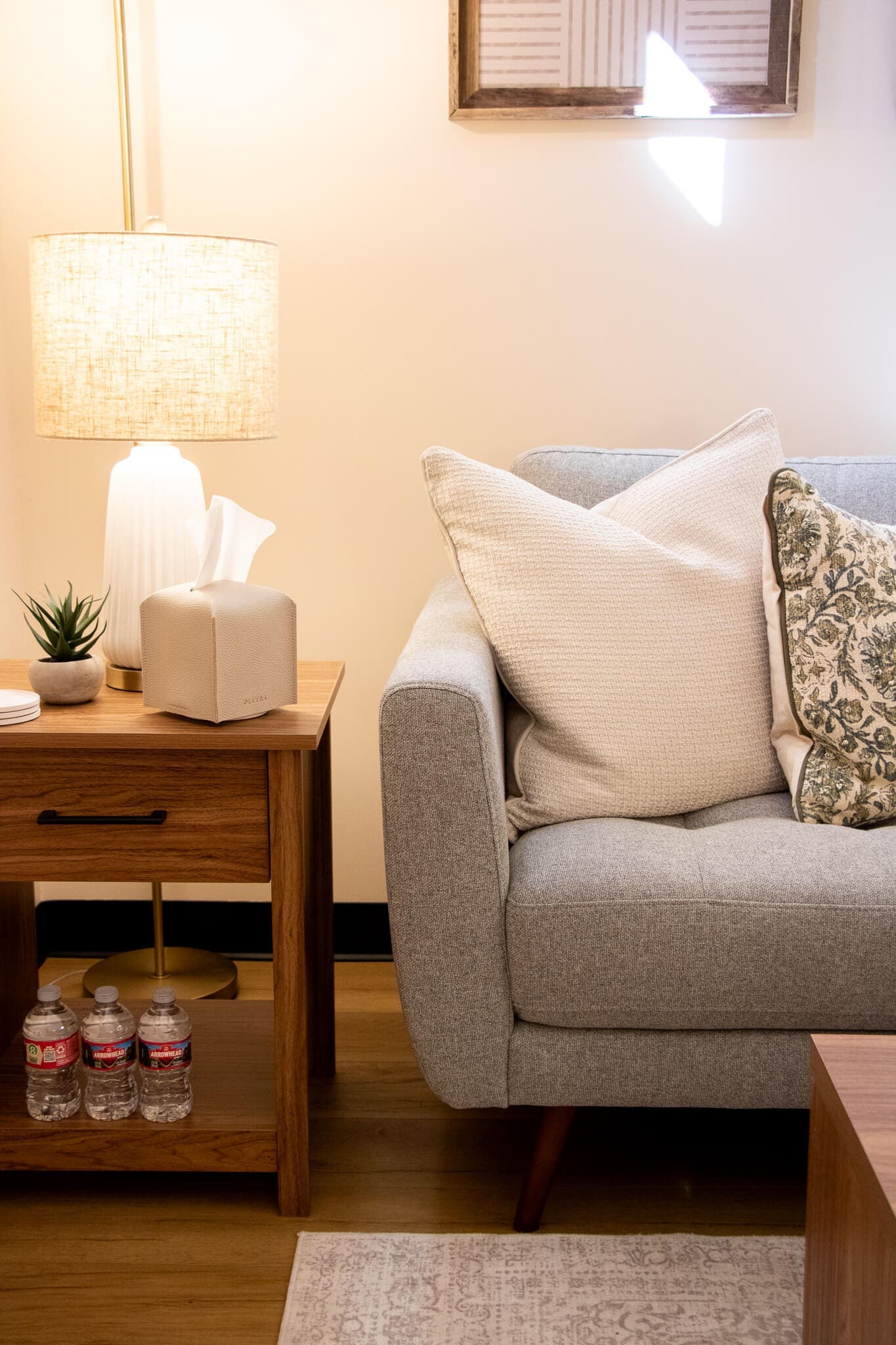 A calming therapy room features soft pillows, a warm lamp, and water bottles nearby. Wondering how EMDR therapy can help heal attachment trauma? Christian counseling in Gilbert, AZ offers a peaceful space to begin that healing process.